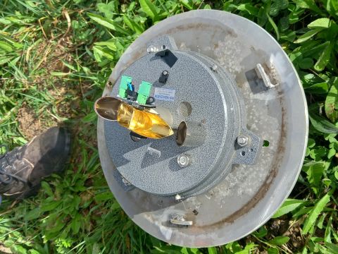 rain gauge opened showing the tipping buckets.